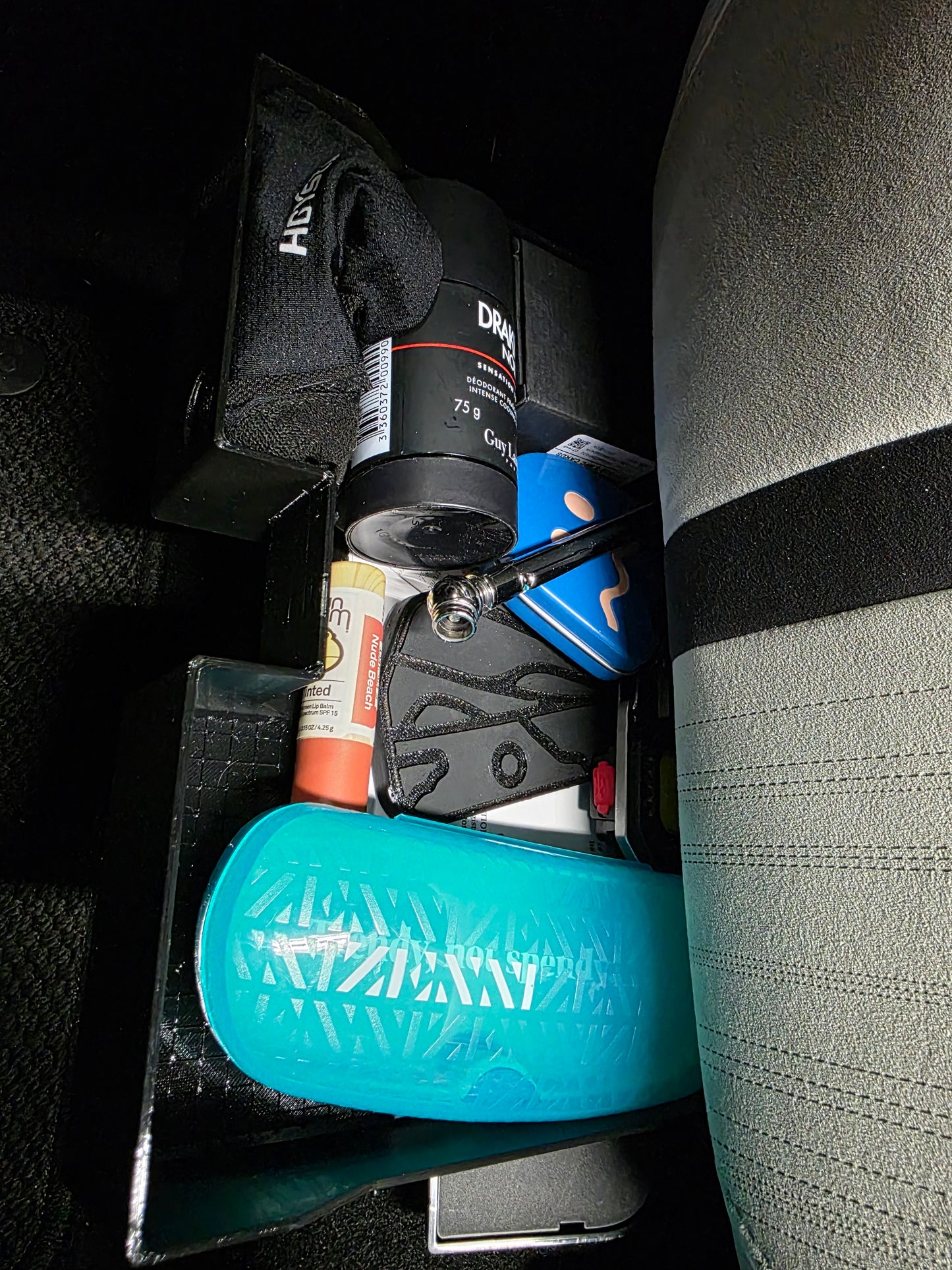 Under seat glovebox tray with flat bottom.