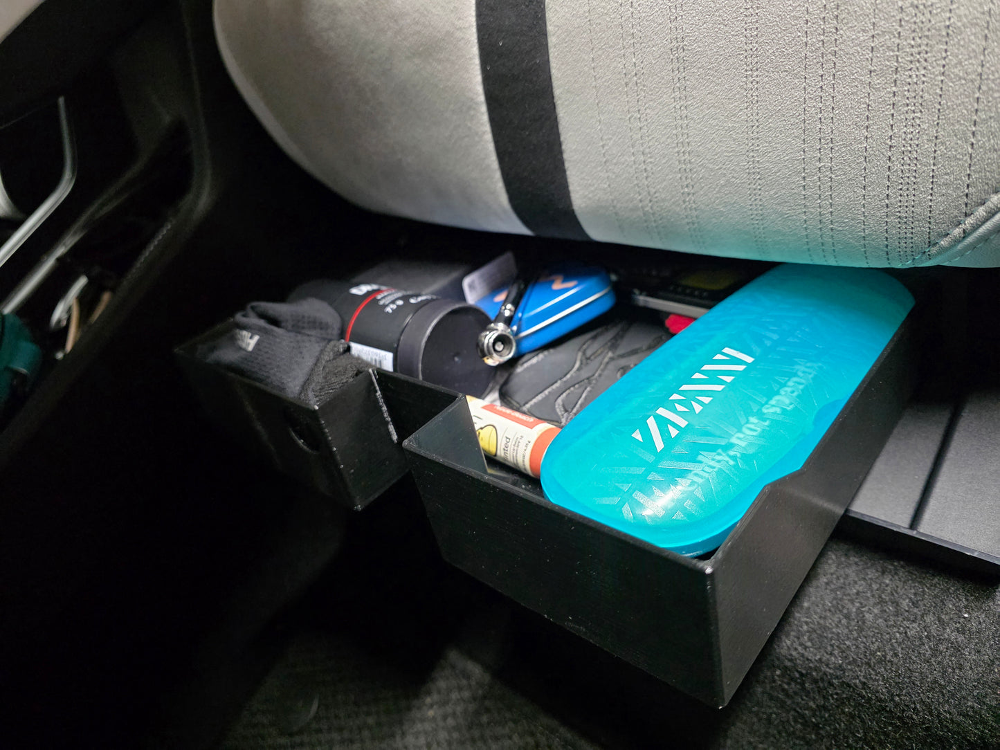 Under seat glovebox tray with flat bottom.